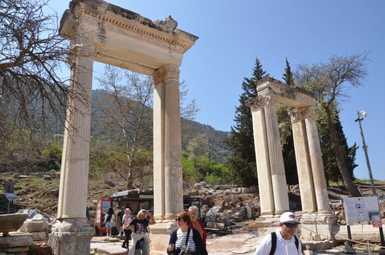 Visitors standing beside monumental columns in Ephesus Ancient City Turkey