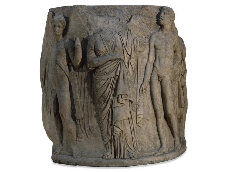 Relief sculpture on a marble column drum from the later Temple of Artemis at Ephesus, featuring ancient mythological figures carved in stone.