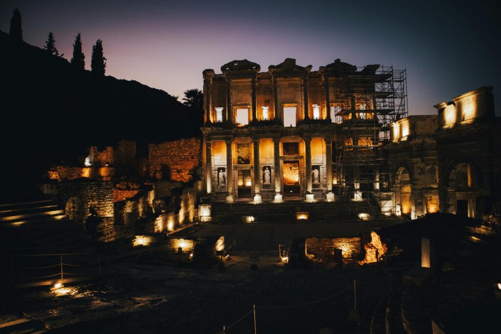 The illuminated façade of the Library of Celsus at night