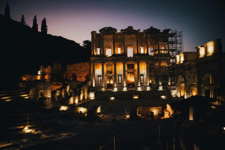 The illuminated façade of the Library of Celsus at night